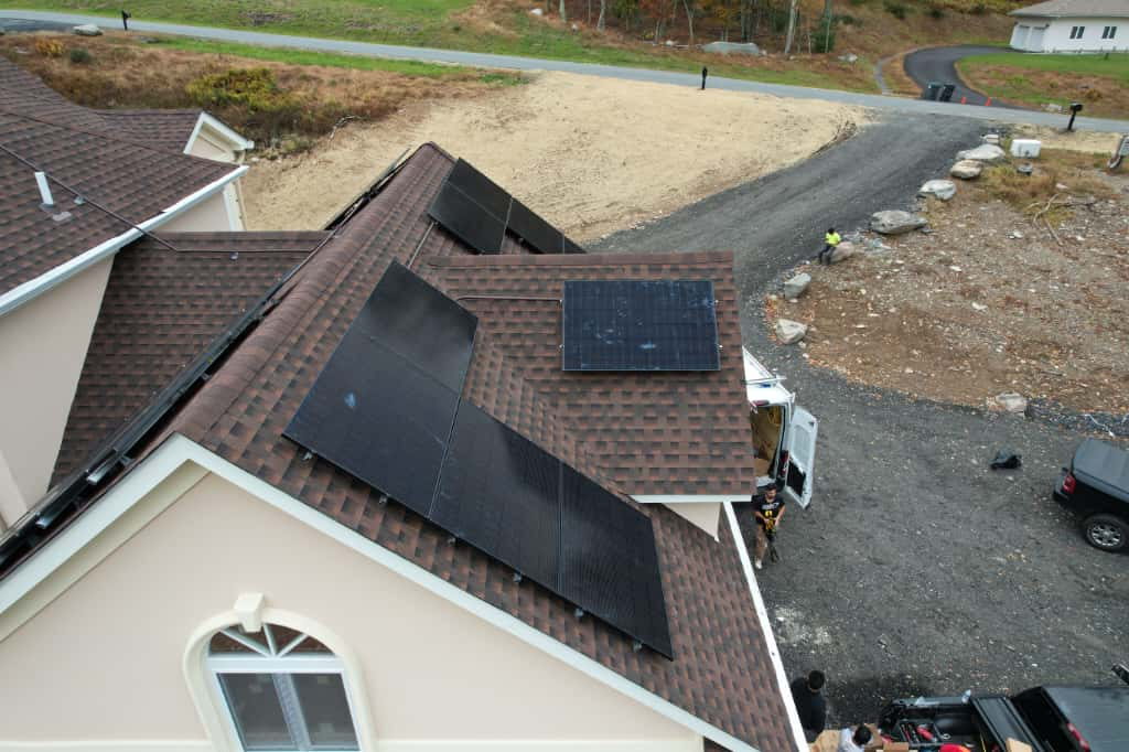 A Solar Bear Energy crew installing solar panels on a roof