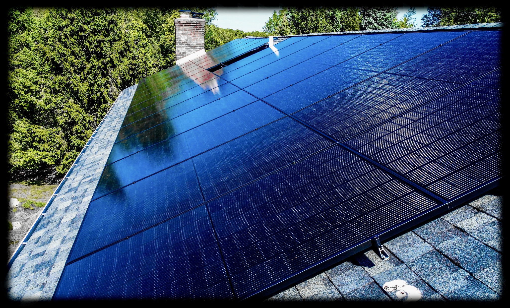 Close-up of sleek all-black solar panels installed on a residential roof